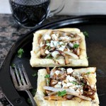 A tray of two pizzas with a cup of coffee, alongside a caramelized onion tart.