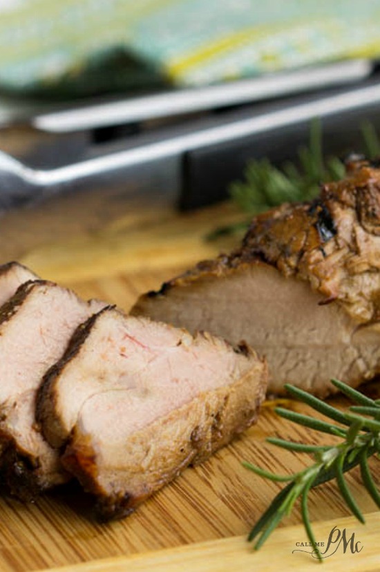 Molasses Glazed Pork Tenderloin has a sweet and savory marinade that adds a beautiful flavor to this recipe. It's juicy, tender, and versatile. Grilled meat is sliced on a wooden board and beautifully garnished with fresh rosemary sprigs.