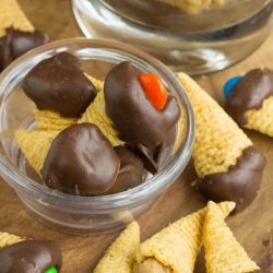 Bugle Bites cones in a bowl with chocolate and M&M's.