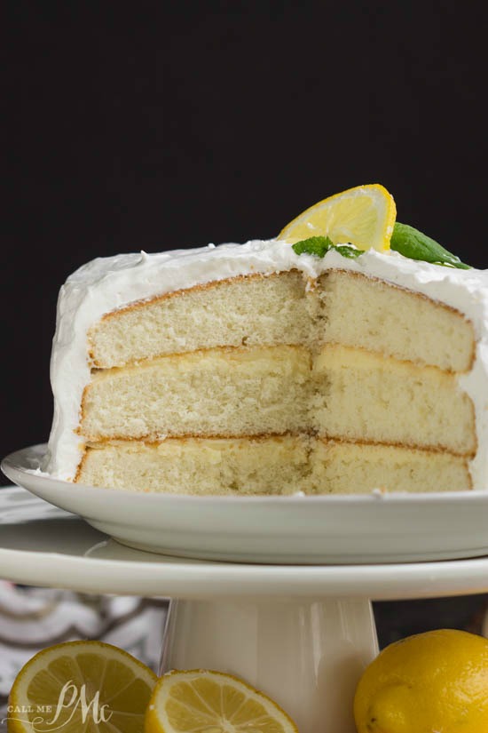 Lemon Cake is a tender white cake filled with tart lemon curd and covered with a fluffy whipped cream frosting.