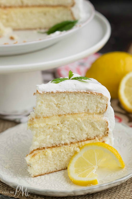 Lemon Cake is a tender white cake filled with tart lemon curd and covered with a fluffy whipped cream frosting.