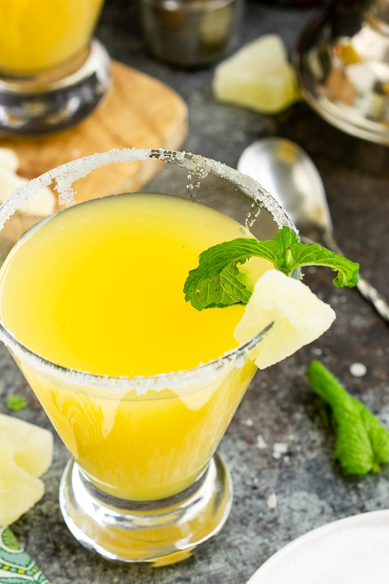 Sweet and festive, a Pineapple Martini is a crazy delicious tropical inspired martini. This is a rum-based cocktail typically served with a sugar rim in a martini glass. Sweet and festive, a Pineapple Martini is a crazy delicious tropical inspired martini.