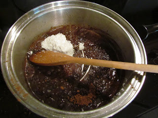 Stirring flour into melted ganache.