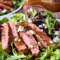 Black and Blue Salad is a hearty entree salad recipe with a spice-rubbed, blackened steak, blue cheese crumbles, and balsamic salad dressing. #salad #steak #steaksalad #blackenedsteak #bluecheese #recipe #entree #dinner #dinnersalad #entreesalad