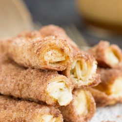 Cinnamon cream cheese rollups on a white plate.