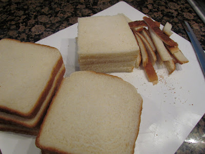removing crusts from white sandwich bread.
