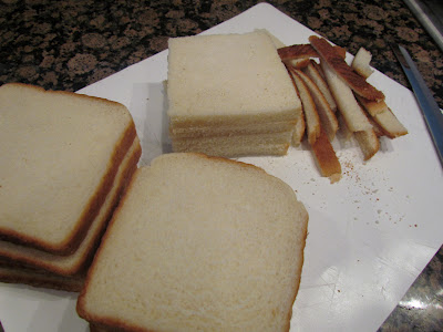 removing crusts from white sandwich bread.