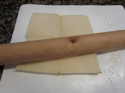 using a rolling bread to flatten slices of white bread for rollups
