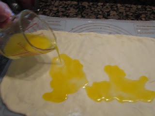 pouring melted butter on sweet pastry dough.