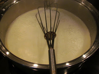 whisk in saucepan of white cheddar cheese sauce.