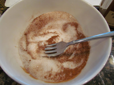using a fork to make cinnamon sugar for cream cheese rollups