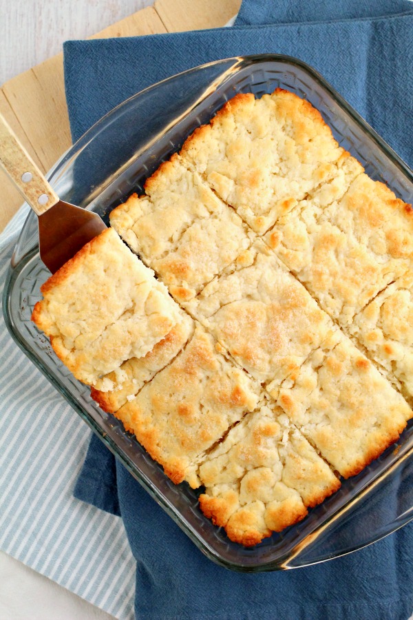 butter swim biscuits in a baking dish.