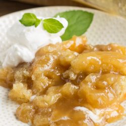 PMc's Caramel Cobbler is rich and buttery and takes just minutes to put together. Perfect for potluck and entertaining. This Caramel Cobbler has a decadent, self-made caramel sauce that you'll want to keep eating and eating!