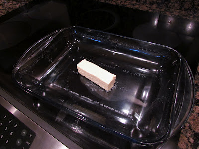 stick of butter in a glass baking dish.