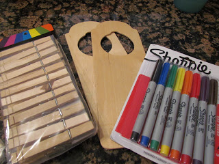 craft supplies for making kid's chore chart - door hangers, permanent markers, and clothespins.