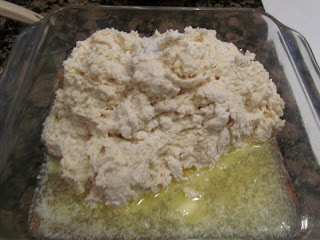 biscuit dough in butter in glass baking dish