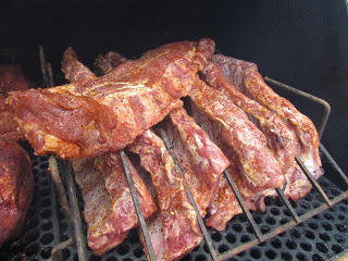 ribs on the smoker halfway through cooking ribs on the grill