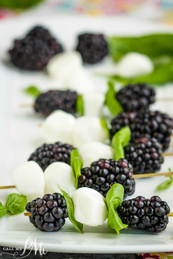 Blackberries and mozzarella cheese balls on a skewer.