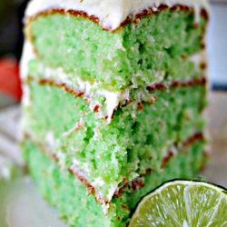 Plated slice of key lime cake with cream cheese frosting.