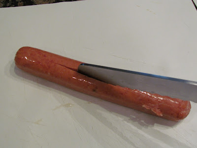 cutting sausage with knife