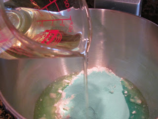 adding oil to citrus cake batter.