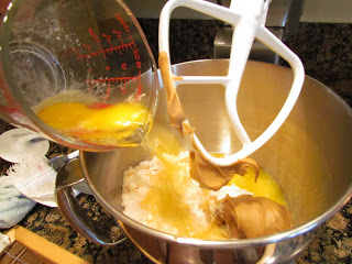 adding ingredients to a mixing bowl.