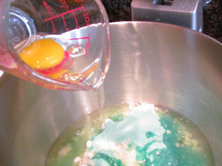 adding eggs to a stand mixer.