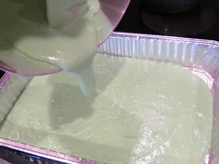 green cake batter in a disposable pan.