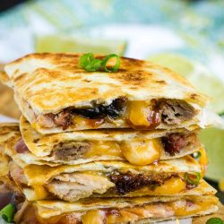 BBQ Pulled Pork Quesadilla, soft flour tortillas are filled with tender pulled smoked pork, spicy barbecue sauce, and gooey cheddar cheese.