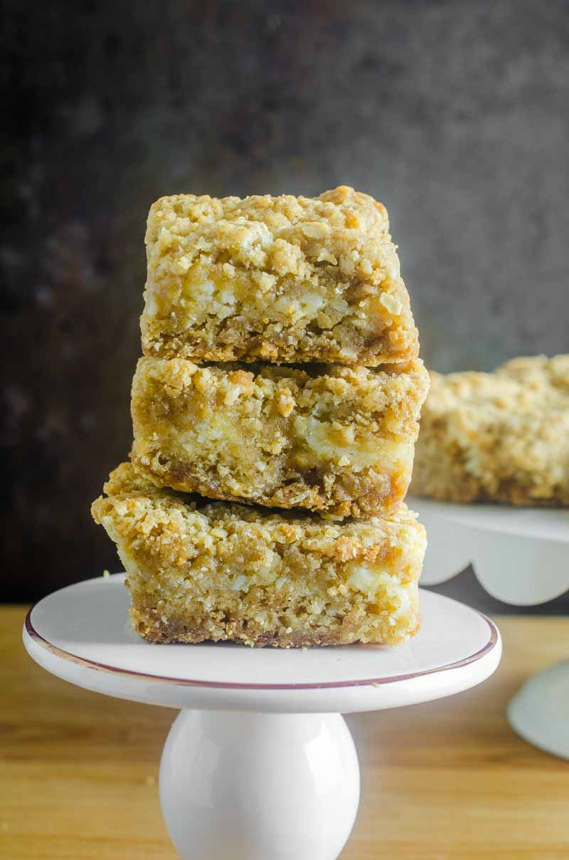 An oatmeal cookie and cheesecake collide in this Oatmeal Cookie and Cream Cheese Bars recipe. They are luscious, sweet, and can be made quickly and easily. #dessert #recipe #creamcheese #oats