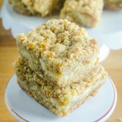 An oatmeal cookie and cheesecake collide in this Oatmeal Cookie and Cream Cheese Bars recipe. They are luscious, sweet, and can be made quickly and easily. #dessert #recipe #creamcheese #oats