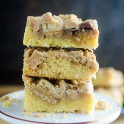 A stack of Peanut Butter Cookies and Cream Bars on a white plate.