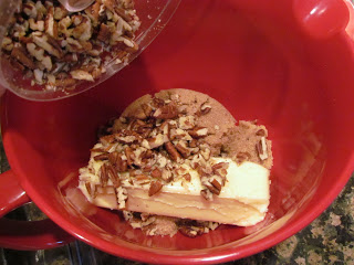 Pecan ice cream served in a red bowl, reminiscent of pecan pie.