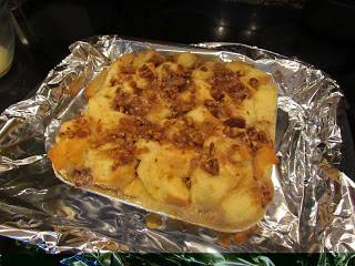A pan of Pecan Pie Bread Pudding sitting on top of foil.