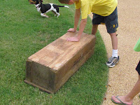 Young boy next to his handmade shoe rack.