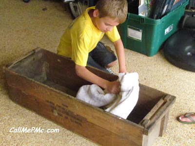 Young boy making a scrap wood shoe rack project