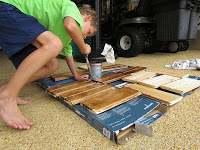 Young boy building something with scrap wood.