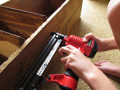 Using a pneumatic nail gun to build a shoe rack.