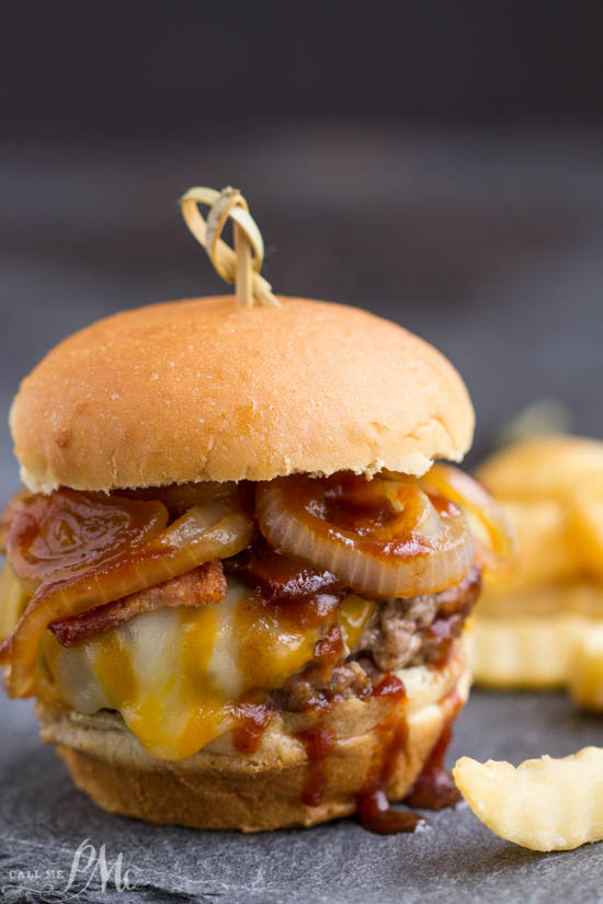 The ultimate burger recipe, Bourbon Burgers, are smothered with cheddar cheese, bacon, caramelized onions and bourbon barbecue sauce!