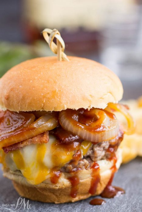The ultimate burger recipe, Bourbon Burgers, are smothered with cheddar cheese, bacon, caramelized onions and bourbon barbecue sauce!