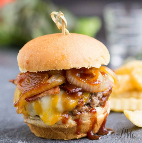 The ultimate burger recipe, Bourbon Burgers, are smothered with cheddar cheese, bacon, caramelized onions and bourbon barbecue sauce!