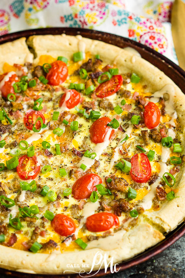 slice of Italian pie with green onions, sausage, bacon, eggs, cheese