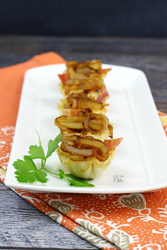 Brie and Onion appetizers on a white platter.