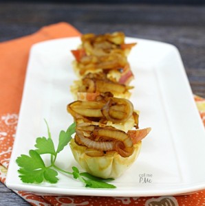 Brie and onion appetizers on a platter.
