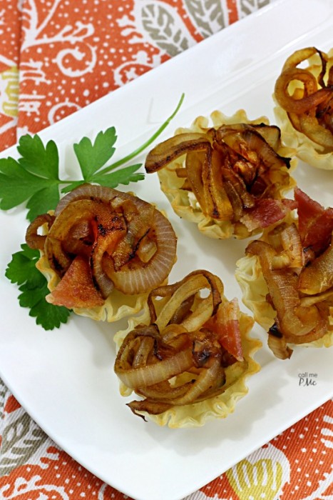 Brie and onion bites on a serving platter.