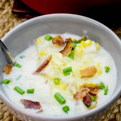 This deliciously creamy Corn and Potato Chowder is filled with diced potatoes, crispy bacon, and a sprinkle of green onion. It's comforting and coziness in a bowl!