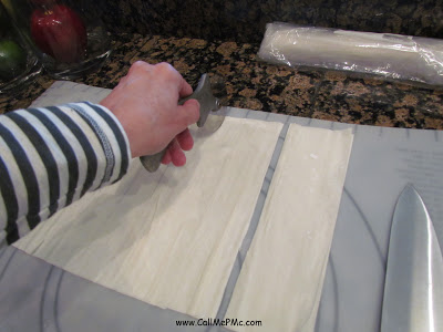 slicing phyllo dough for a brie appetizer recipe.