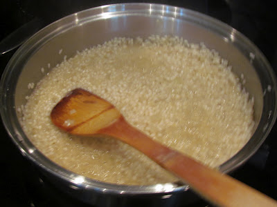 cooking Arborio rice in a saucepan for risotto recipe.