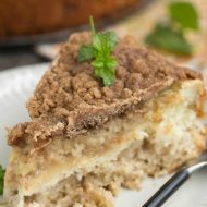 Apple Cinnamon Coffee Cake is a tender, spiced apple cake with a thread of cream cheese running through it and a nutty cinnamon pecan streusel sprinkled on top!