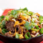 Irish Pub-Style Potato Nachos are an Irish twist of popular comfort food. Potato fries form the base for shredded roast, cheese, and more! #nachos #fries #potatonachos #Irishnachos #roast #beef #roastbeef #cheddar #gameday #tailgating #appetizer #entree #partyfood